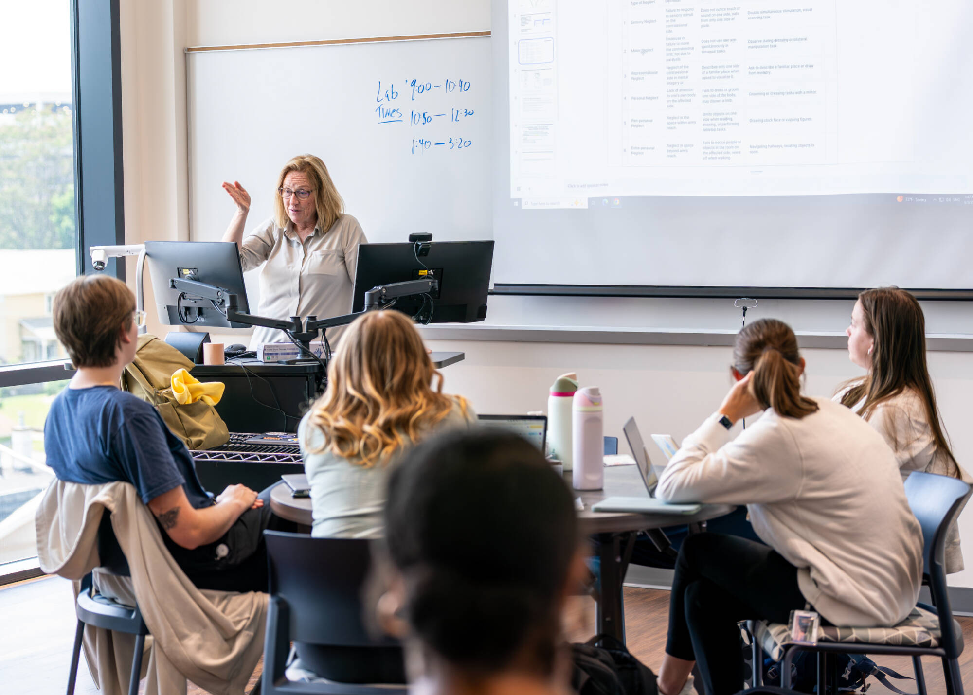 Assistant Professor Lori DeMott, top, teaches occupational therapy students inside the Model Living Suite at the DeVos Center for Interprofessional Health on June 5. (Photo releases on file)